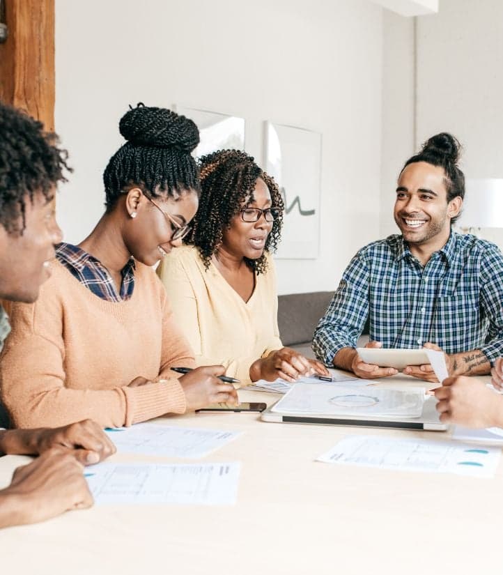 A team reviewing work together around a table