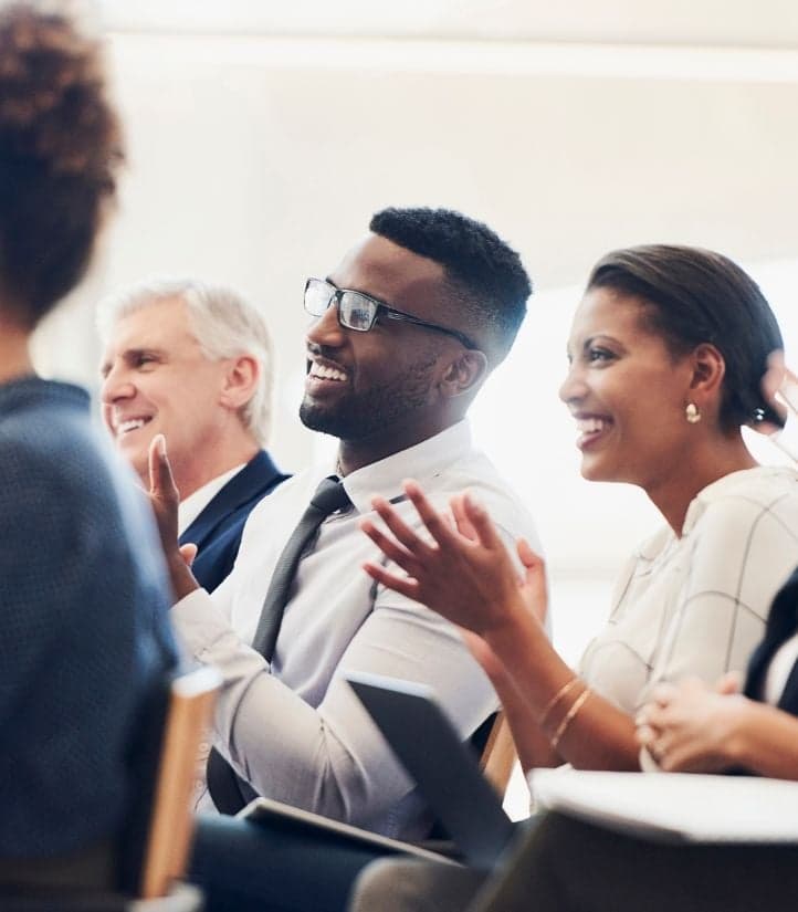An audience applauding at a professional event