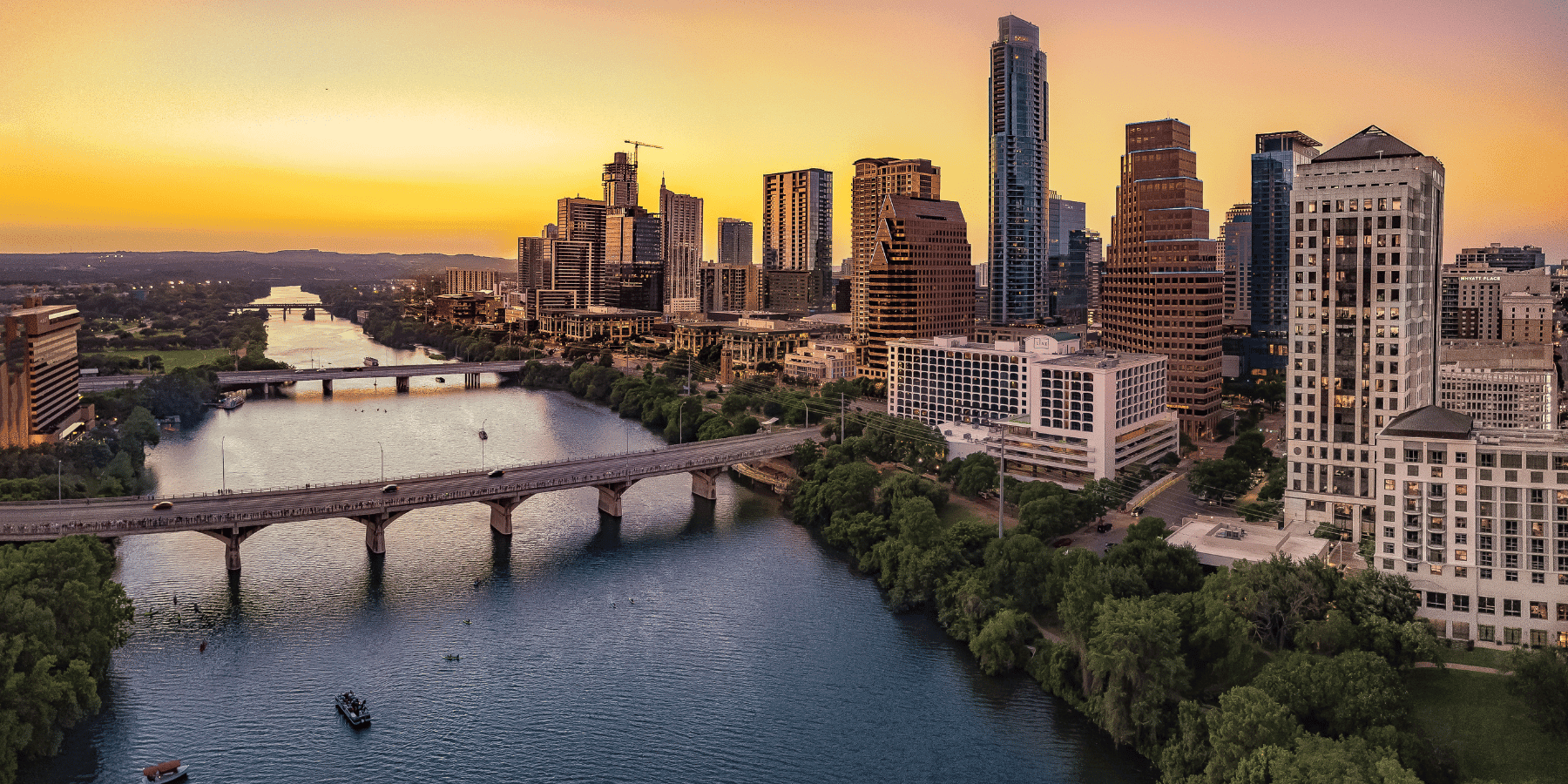 The Austin, Texas skyline over Lady Bird Lake at sunset