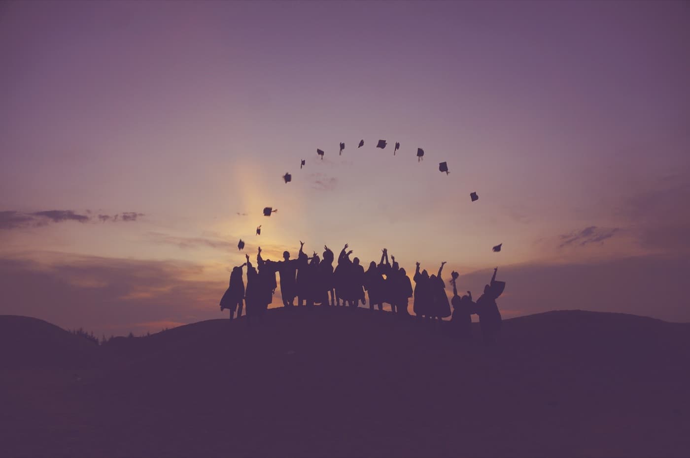 Graduates celebrating in caps and gowns